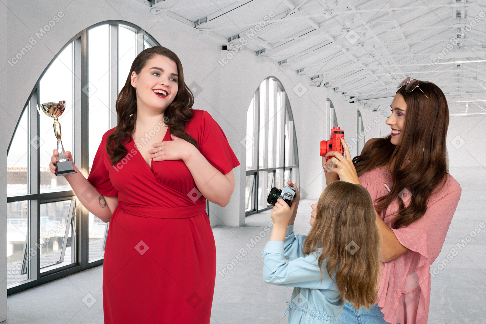 Woman and girl taking a picture of a woman in a red dress
