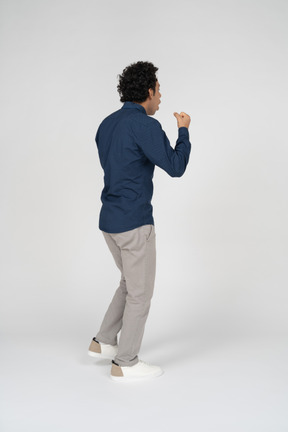 Side view of a man in casual clothes gesturing