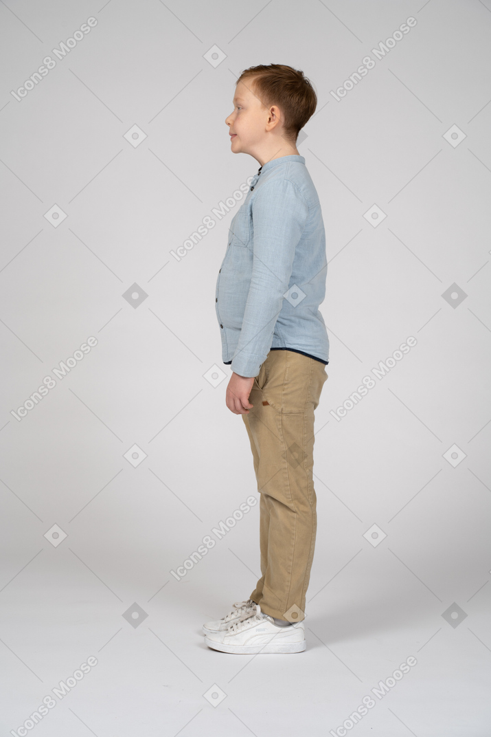 Side view of a boy making faces