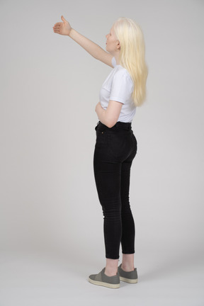 Back view of a blonde woman with her arm raised