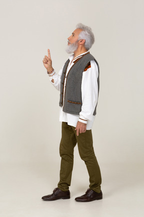 Side view of a man in casual clothes raising his finger