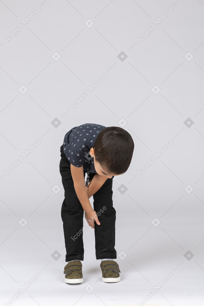 Front view of a boy bending down