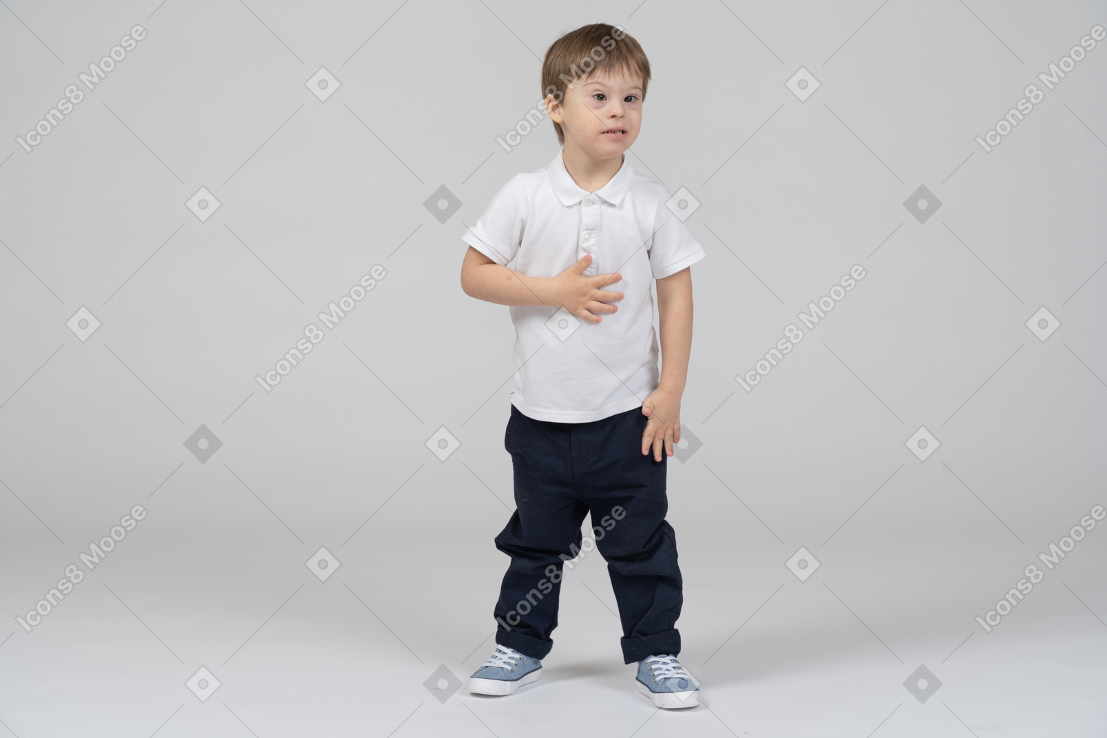 Little boy standing with hand on chest