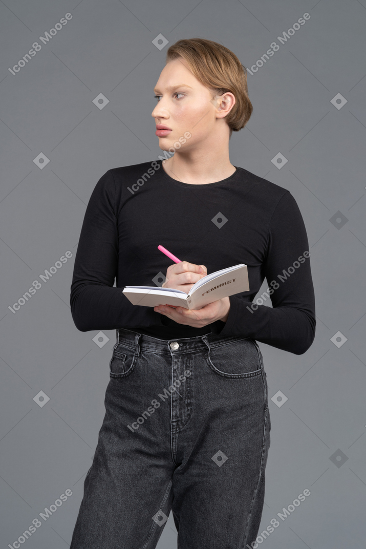 Person looking to the side while writing in notepad