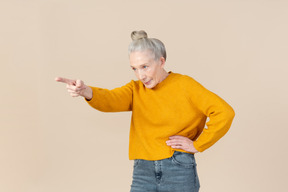 Elegant older woman pointing at something