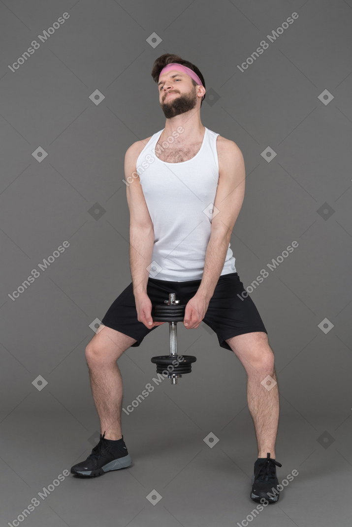 Man doing his best to lift a dumbbell