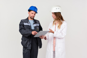 Female and male engineer colleagues discussing some work stuff