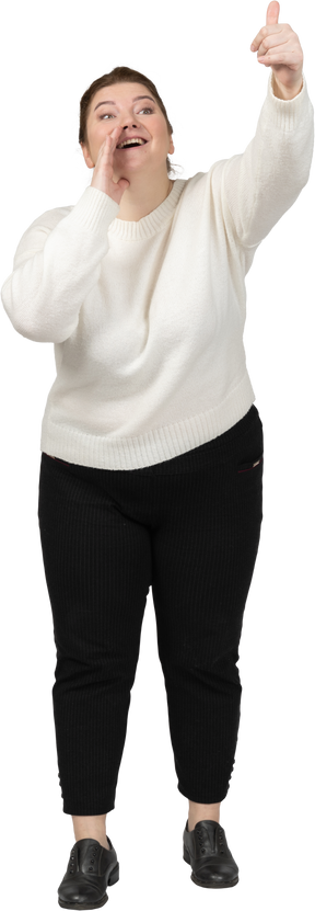 Front view of a plump woman in casual clothes calling someone