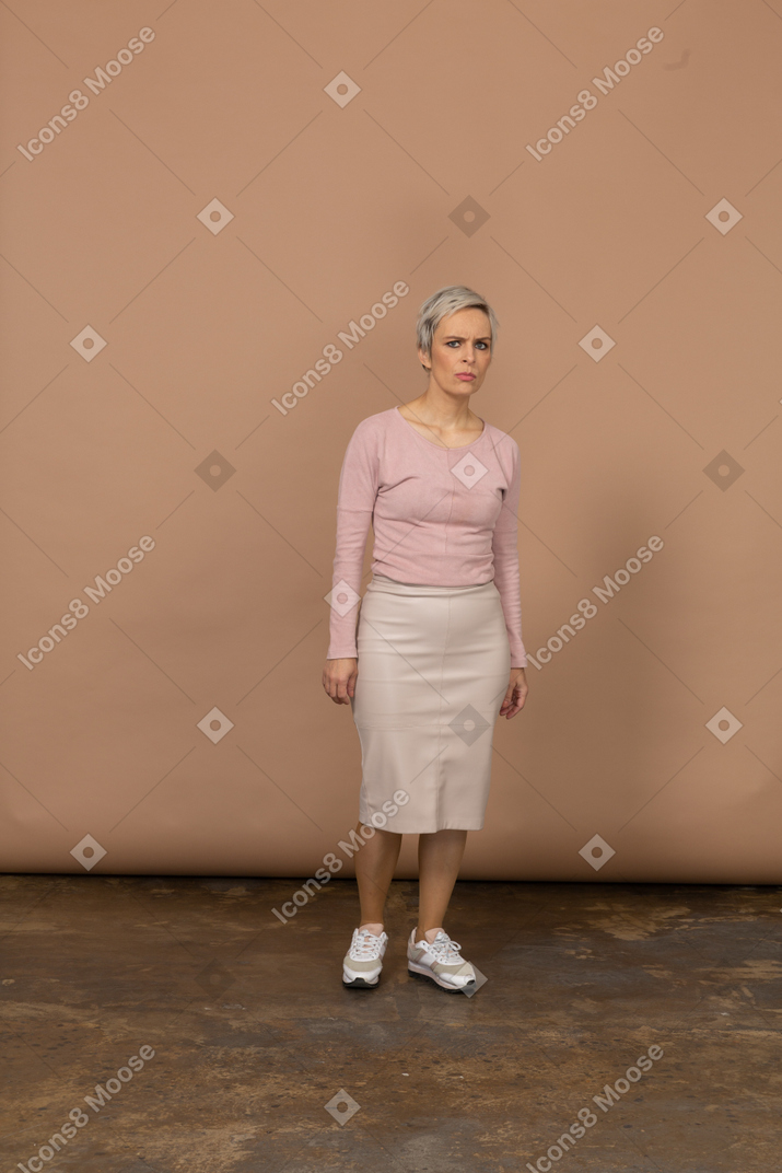 Front view of a confused woman in casual clothes looking at camera
