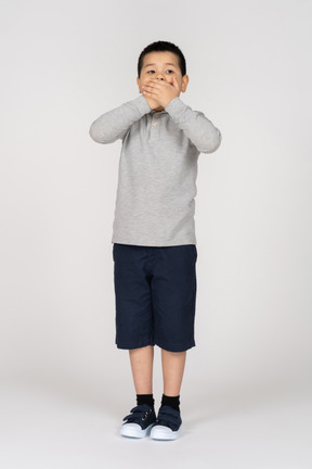 Boy covering mouth