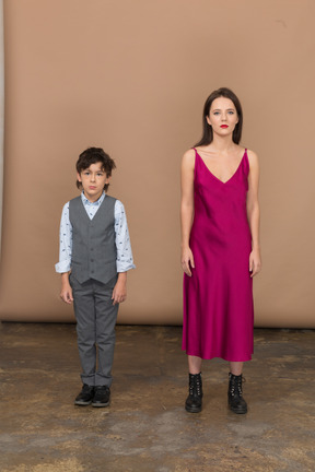 Front view of a boy in suit vest and young woman