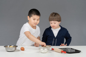 Boys are focused on baking process