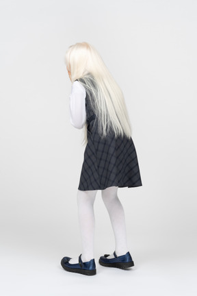 Back view of a schoolgirl with platinum blonde hair