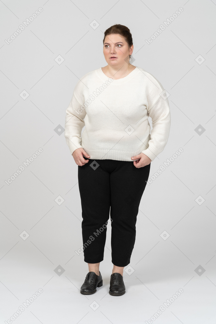 Extremely surprised plump woman in casual clothes