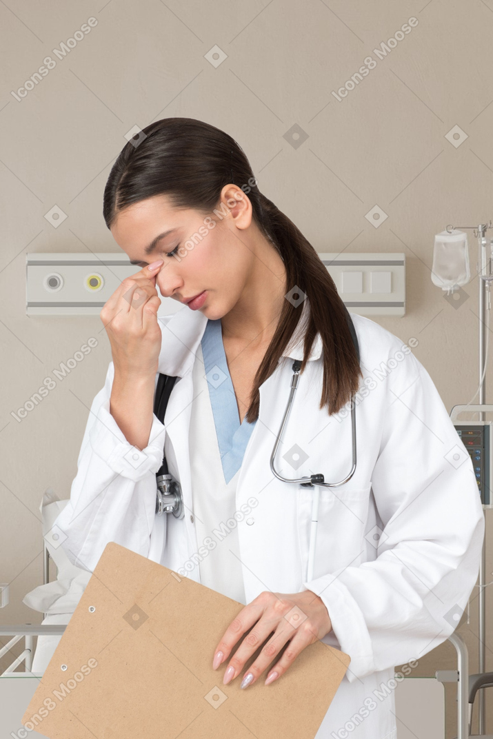 Exhausted woman doctor in the hospital