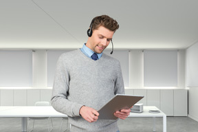 A man wearing a headset and using a tablet