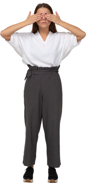 Front view of a young lady in office clothing shutting her eyes