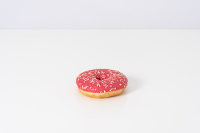 Pink donut on a white background