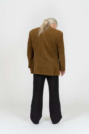 Gray-haired man standing with his head down