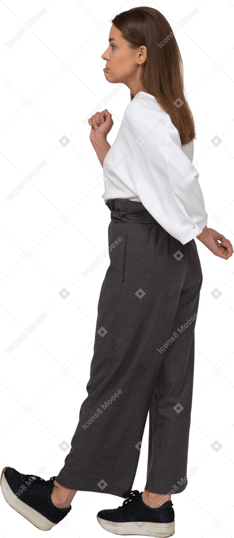 Side view of a confused young lady in office clothing raising hand