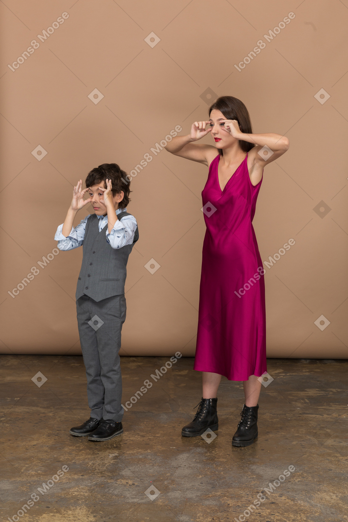 Side view of a boy and woman widening their eyes