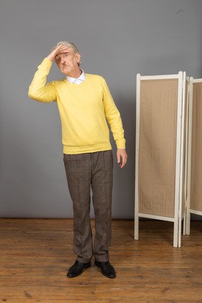 Front view of an old man looking faraway