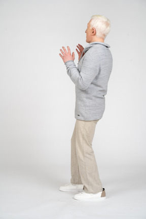 Side view of a man standing and looking scared