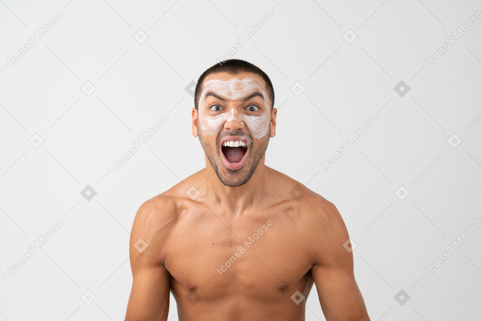 A shirtless man with facial mask screaming