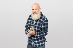 Bearded man holding a rolled newspaper