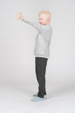 Boy in casual clothes raising his hand