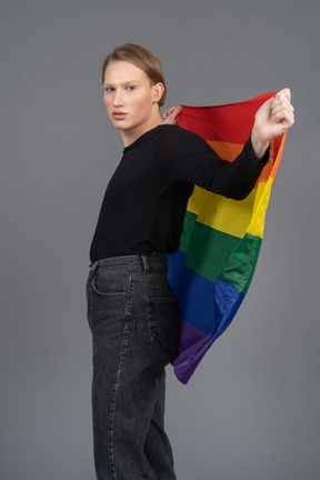 Person holding a rainbow flag