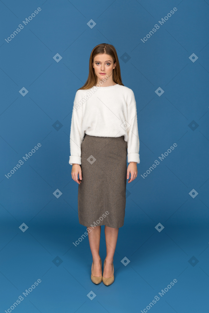 Young businesswoman disapprovingly looking