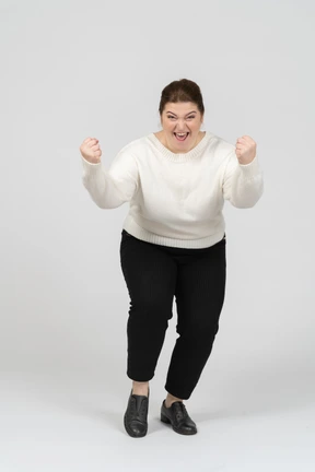Front view of a happy plump woman in casual clothes