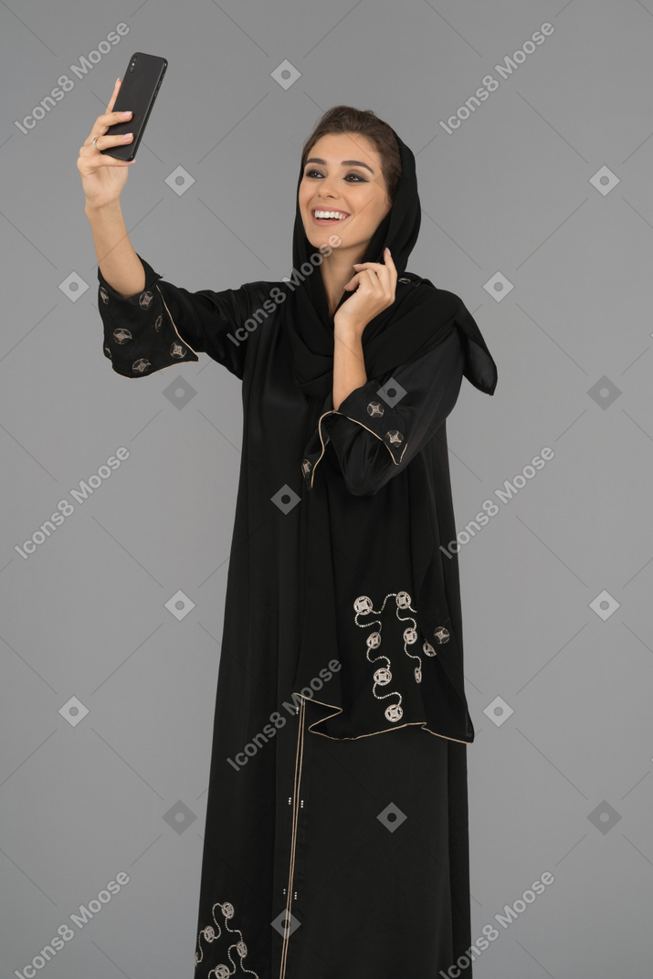 A cheerful muslim woman making a selfie