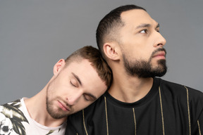 Man resting head on boyfriend's shoulder