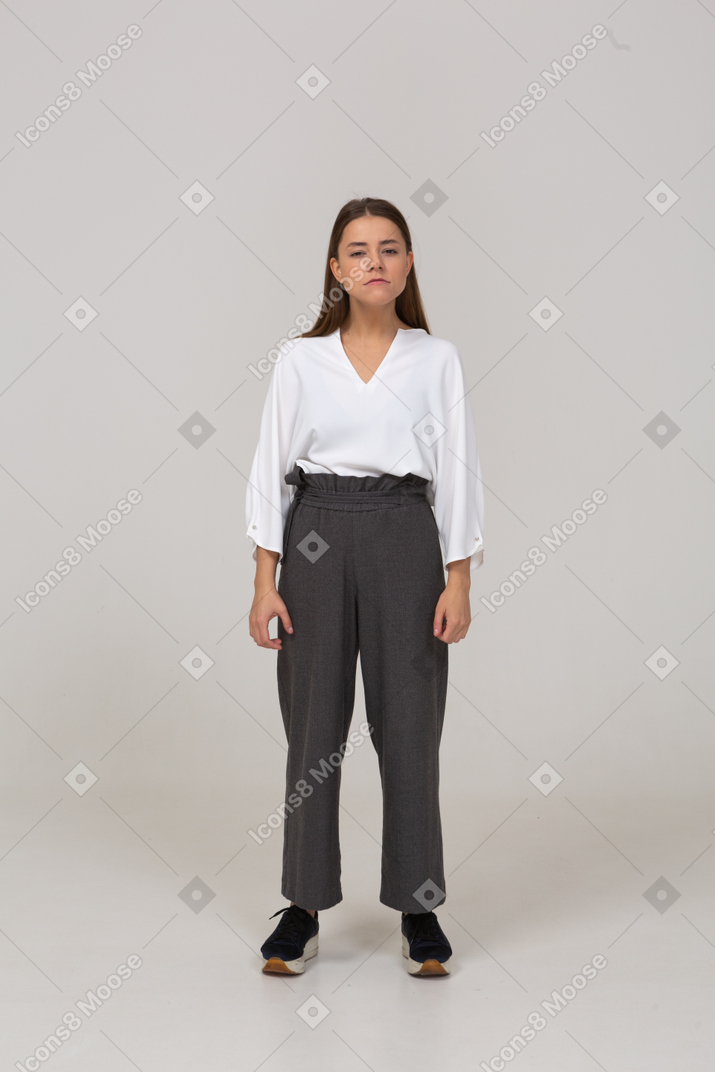Front view of a suspicious young lady in office clothing