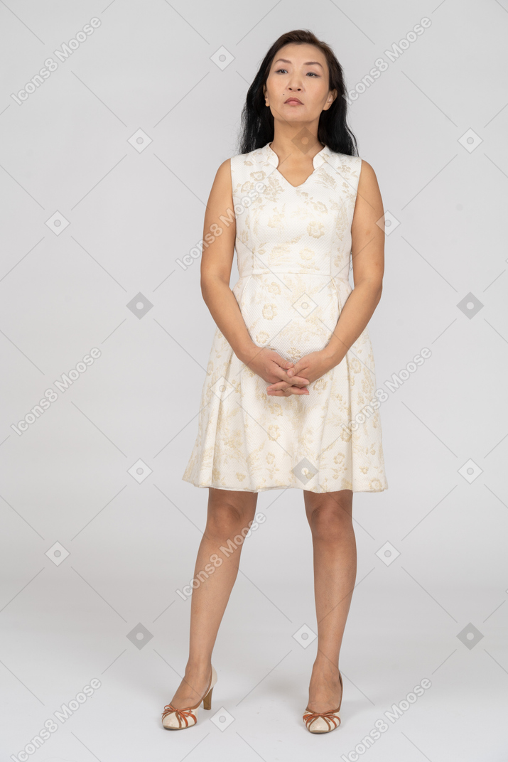 Woman in a white dress standing