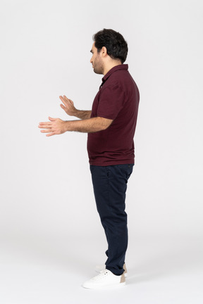 Side view of man outstretching his arms