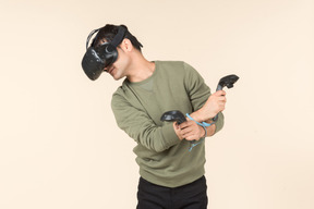 Young caucasian guy playing a virtual reality game