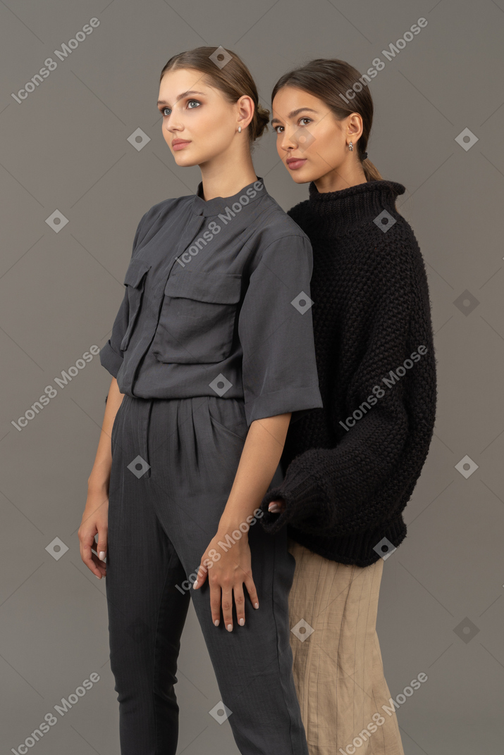 Two women posing and looking away