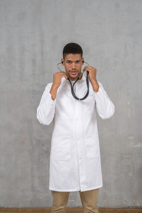 Male doctor using his stethoscope