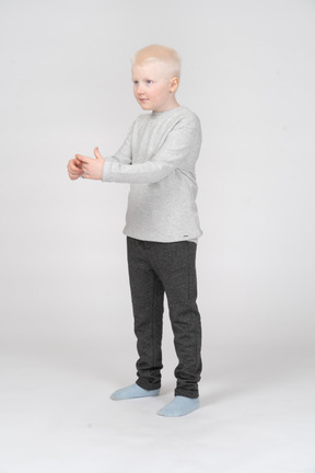Little boy making a circle with his hands