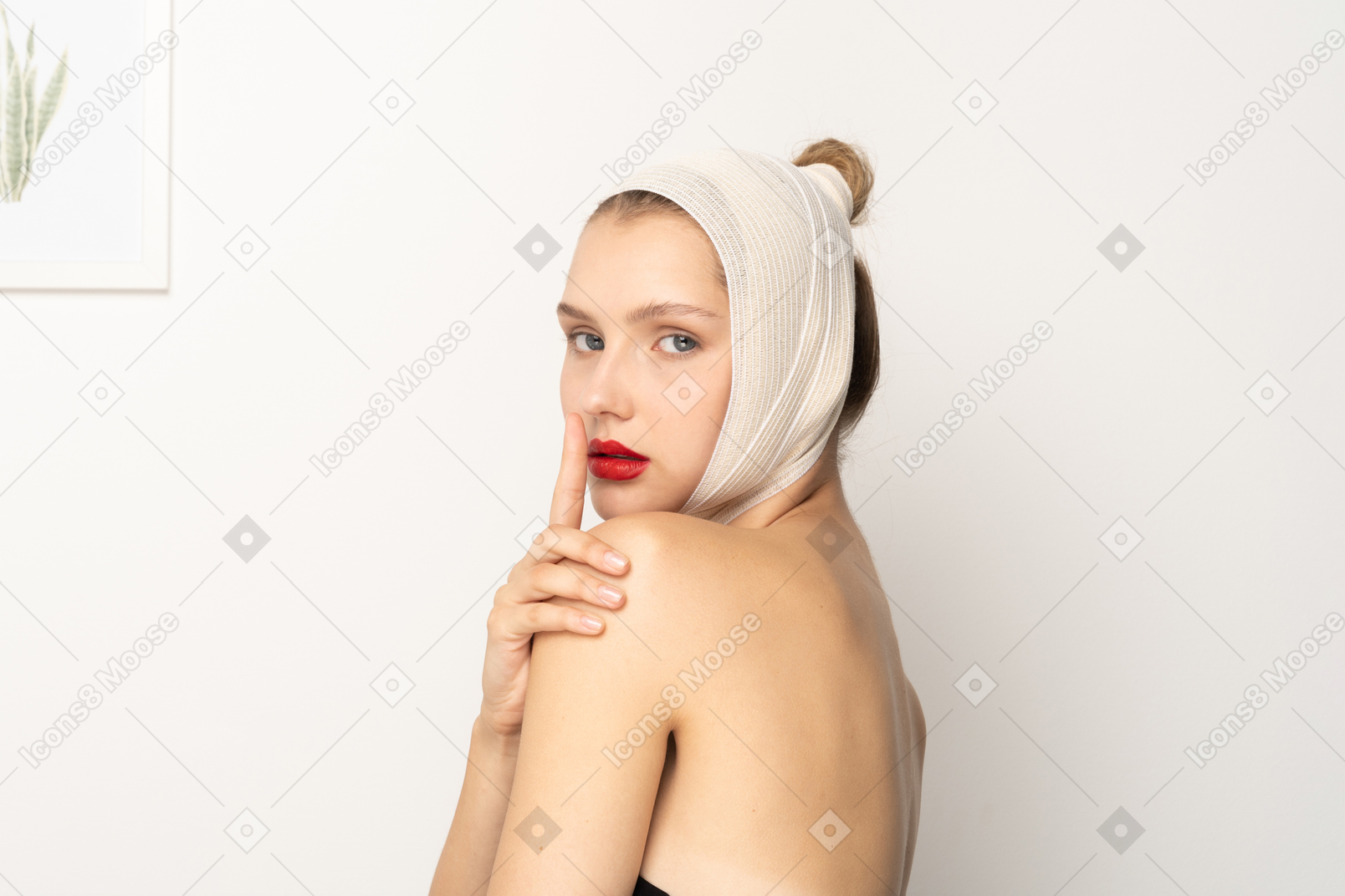 Young woman with head bandage making hush gesture