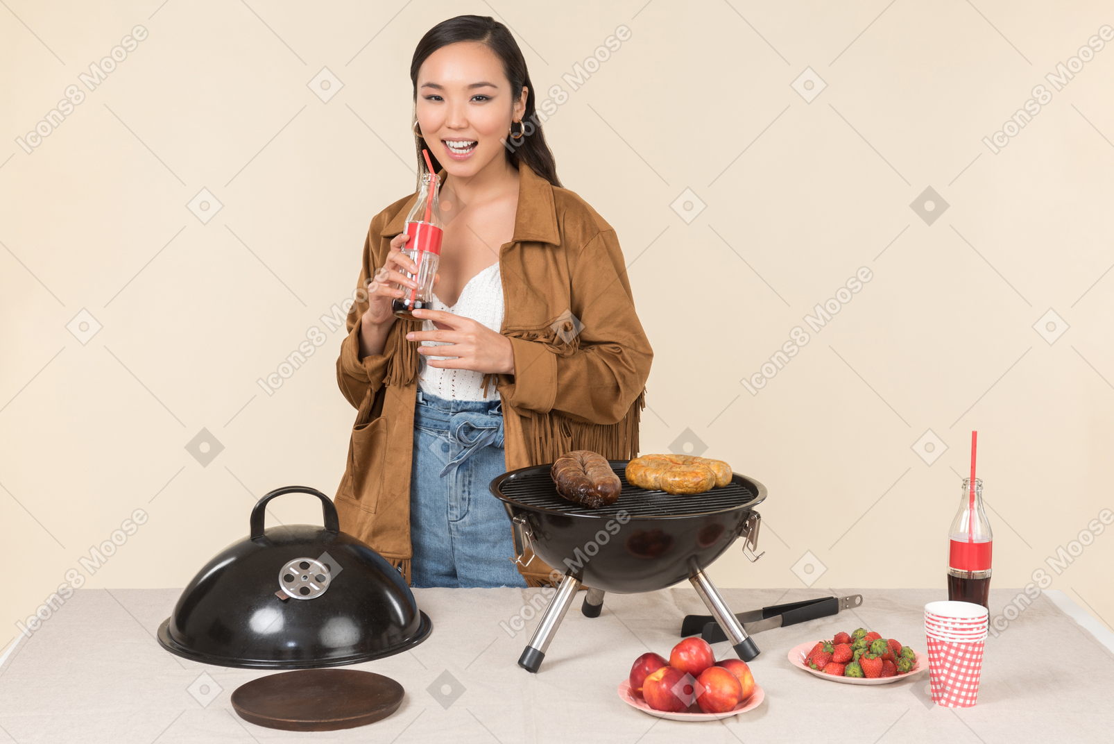 Laughing young asian woman holding coke and doing bbq