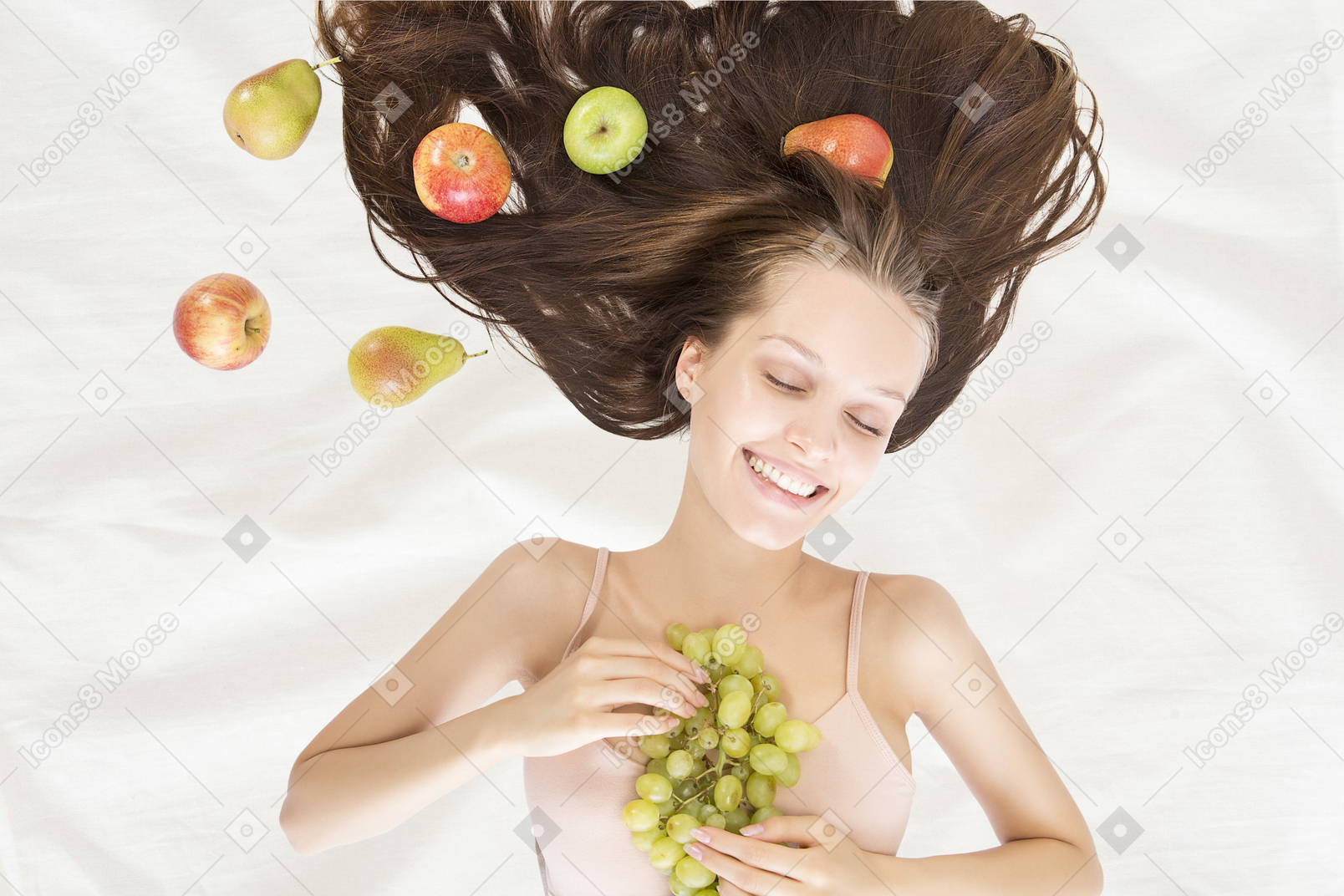 A woman holding a bunch of grapes
