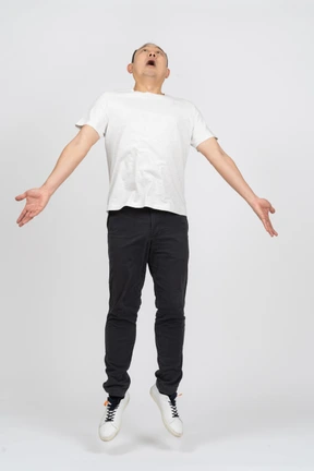 Man jumping with outstretched arms