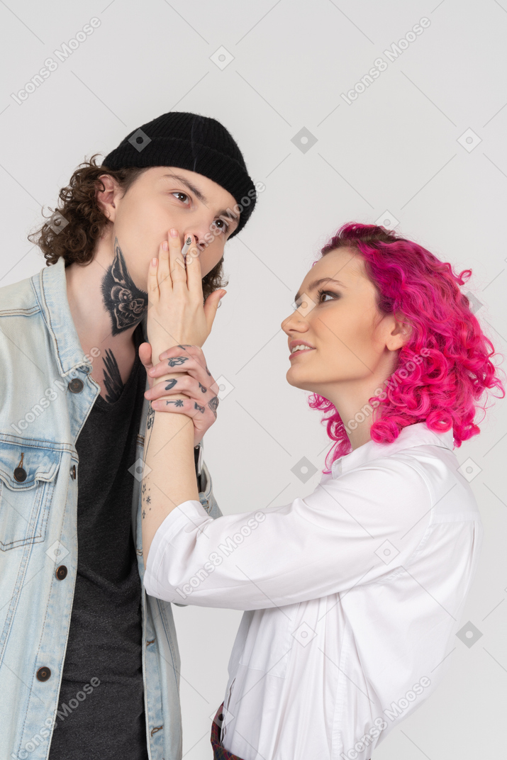 Woman looking at her boyfriend giving him a smoke