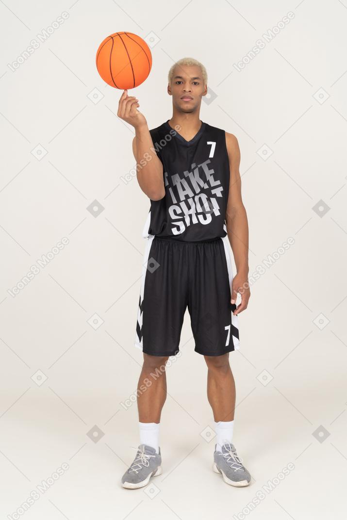 Front view of a young male basketball player holding a ball