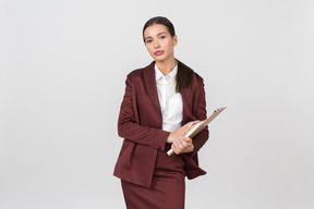 Attractive formally dressed woman holding a clipboard