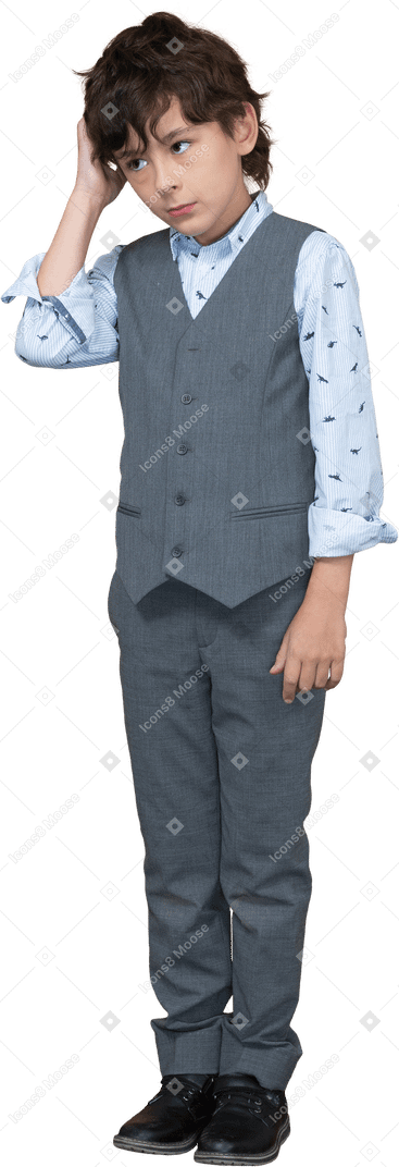 Front view of a boy in grey suit scratching head